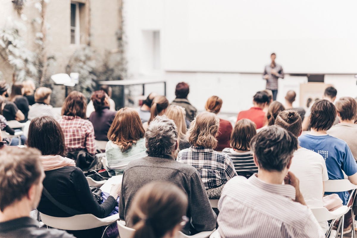 Blurred image of a speaker at a conference