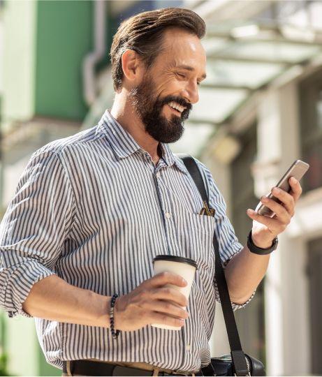 Happy person looking at phone traveling