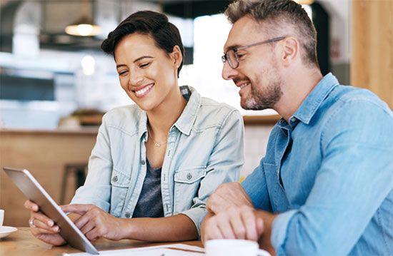 Two people discussing vendor payment program