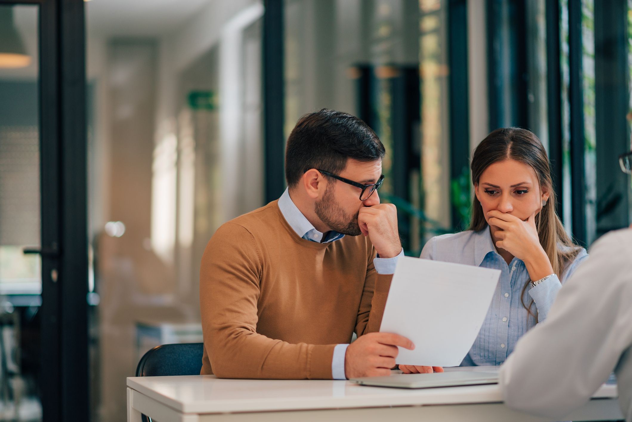 Stock image of two young people looking at paperwork