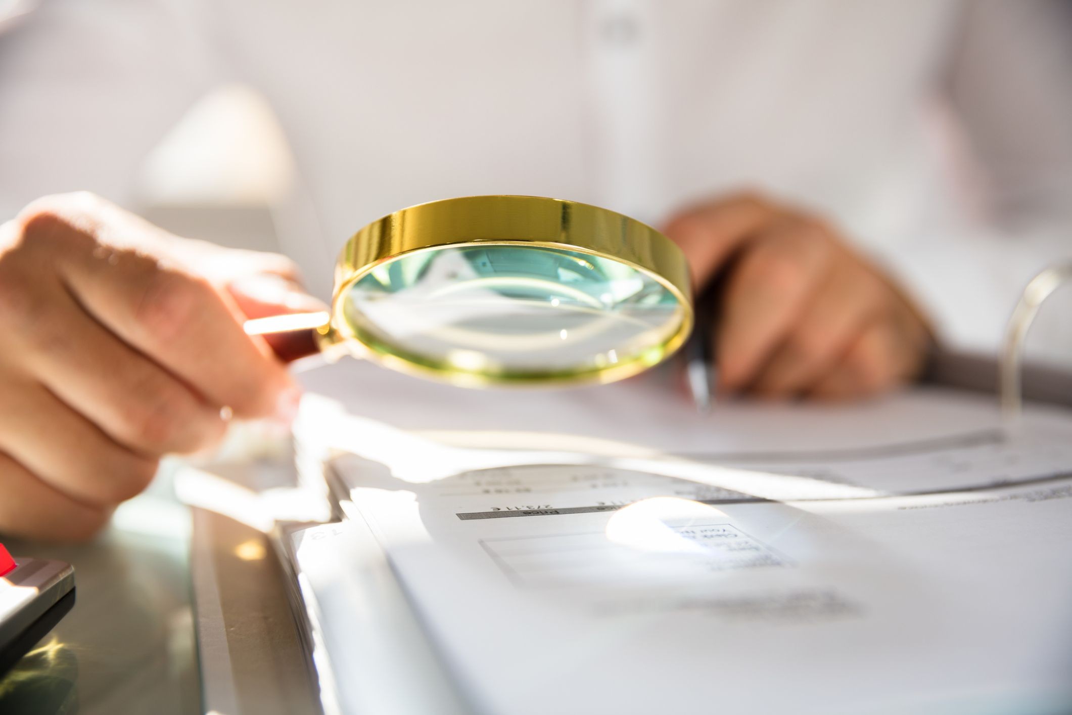 Auditor using a magnifying glass