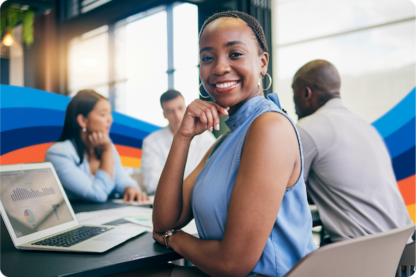 African American woman in an office, smiling at a camera